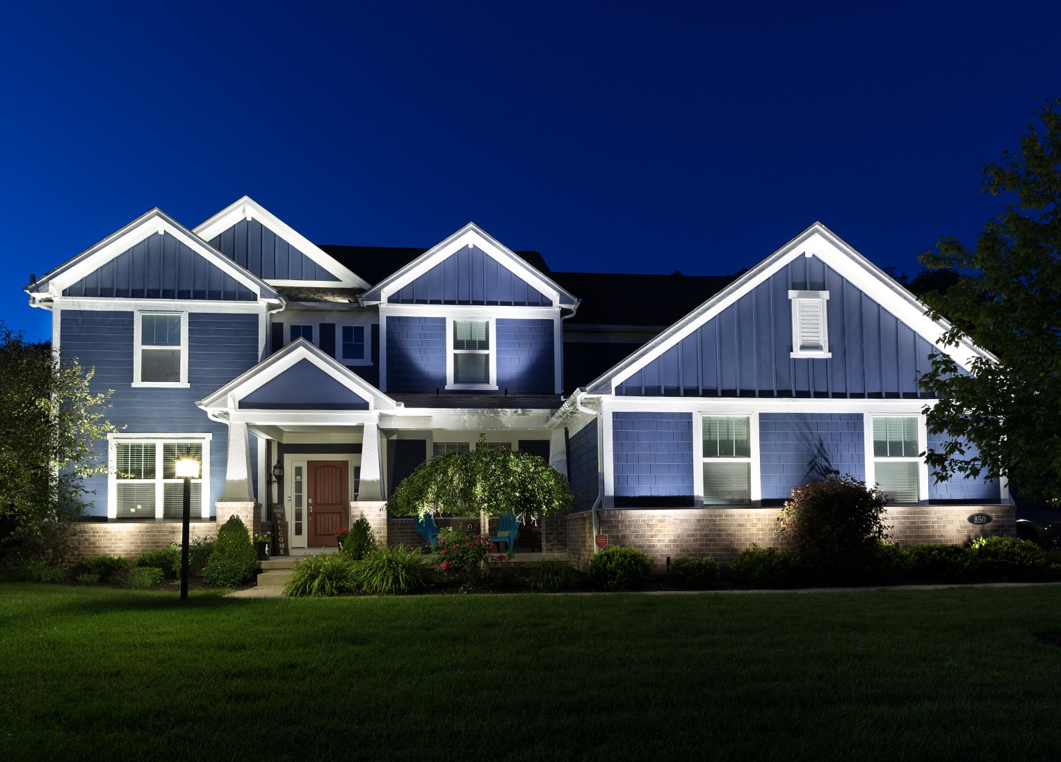 Process-1 front view of home lit at night