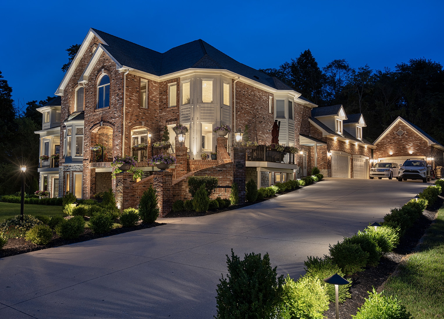 outdoor lighting of a home sitting on a hill at night