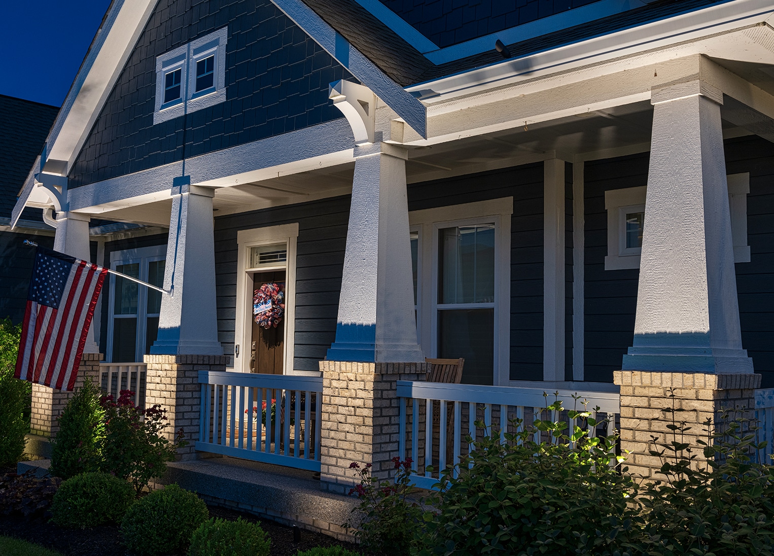 shrout Home with outdoor columns lit at night